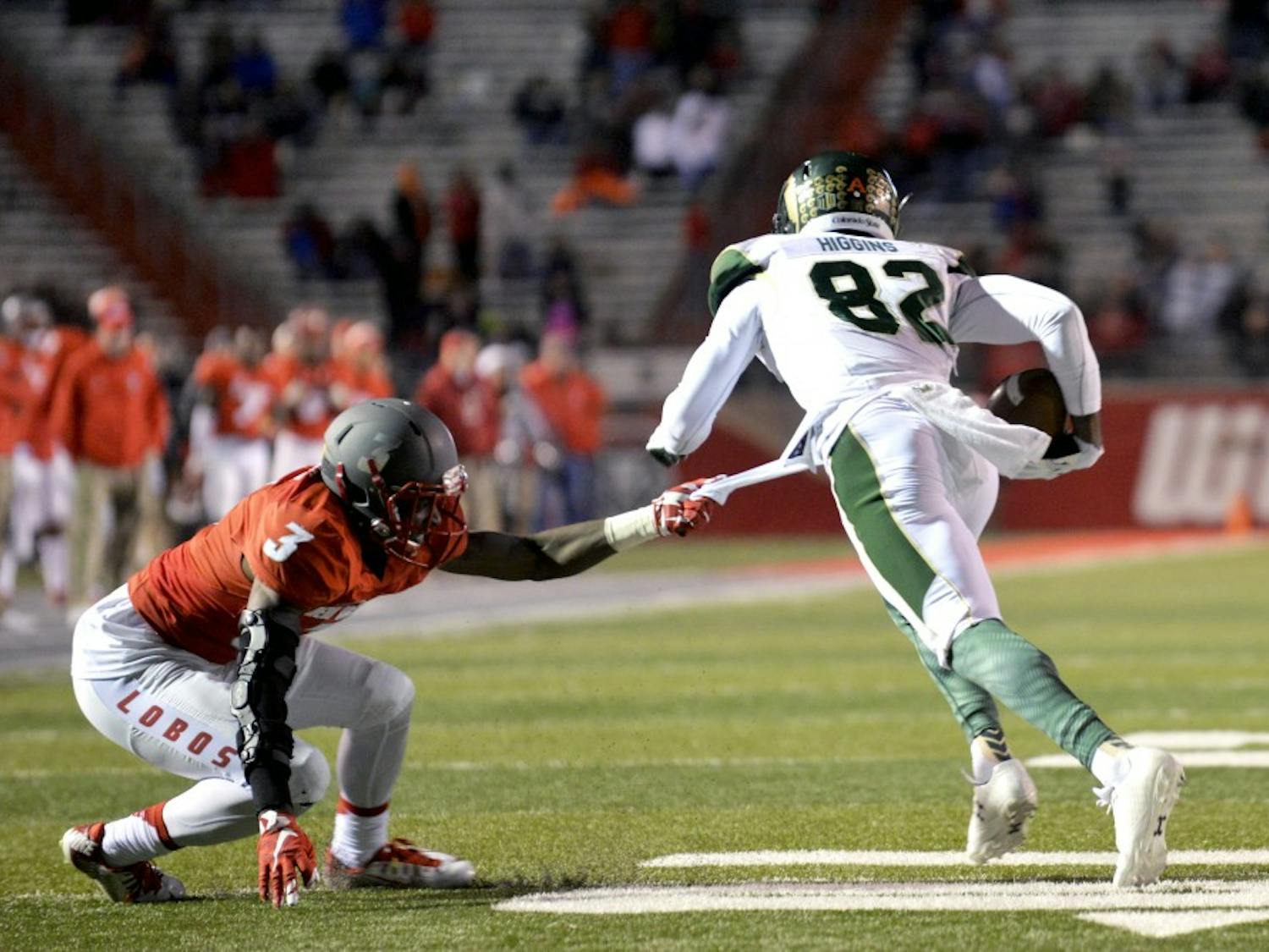 Senior cornerback Cranston Jones tries to bring down CSU's Rashard Higgins at University Stadium Saturday night. The Lobos lost to the Rams 28-21 and lost their chance to make it to the Mountain West Championships. 