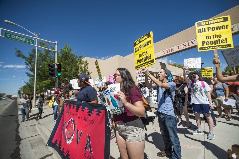 Protesters stand in front of the UNM Bookstore during a demonstration against the North Dakota Access Pipeline Thursday, Sept. 8, 2016. Indigenous groups such as the Kiva Club are opposed to the election of President-elect Donald Trump, saying his values contradict their beliefs.