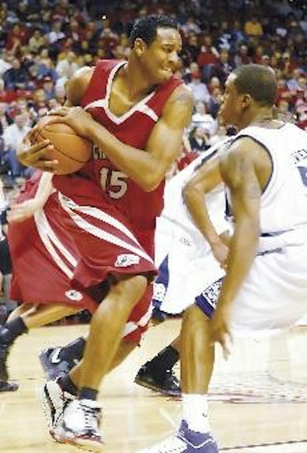 UNM guard J.R. Giddens grabs a rebound while being guarded by TCU's Neiman Owens during  the play-in game of the Mountain West Conference Tournament on Tuesday in Las Vegas. The Lobos lost 62-54 to the Horned Frogs.