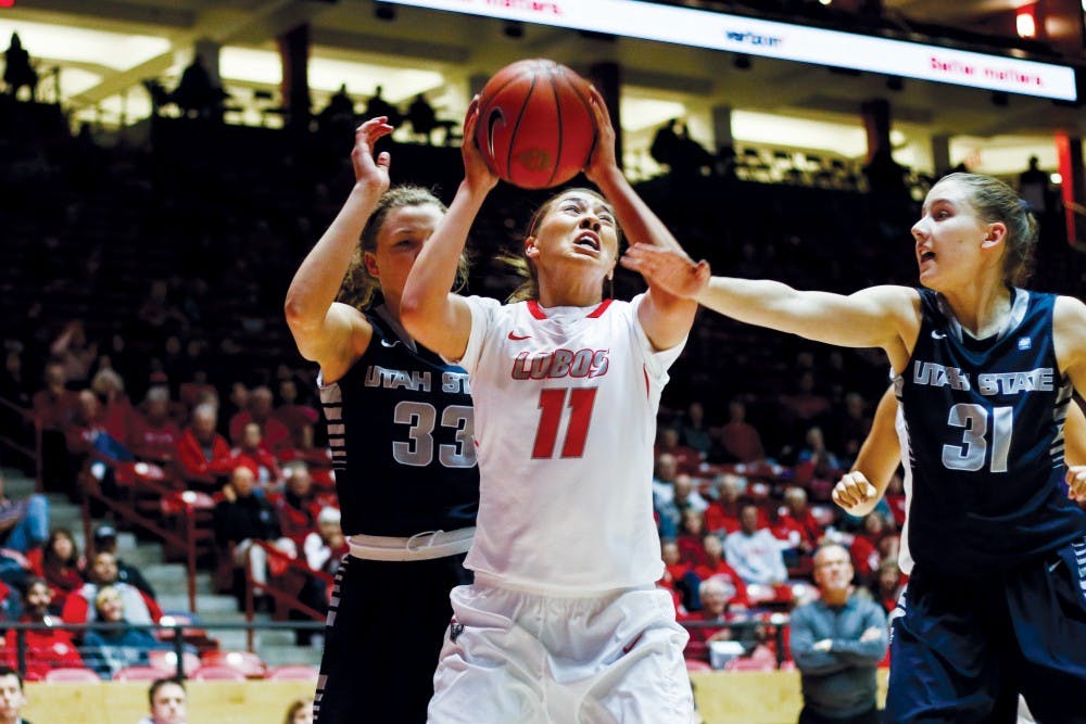 Senior forward Alexa Chavez attempts an inside jump shot while being defended by Utah State players Wednesday night at WisePies Arena. The Lobos lost to San Jose State this past weekend 59-58. 
