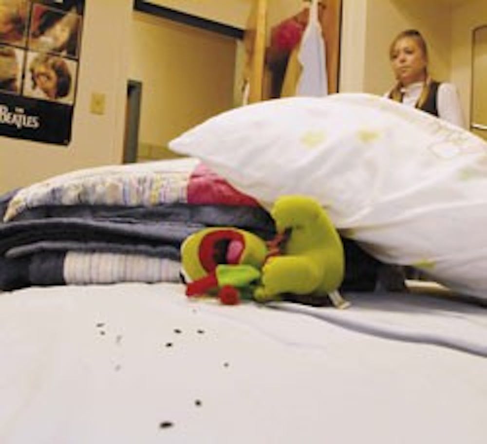 Student Mary Fortuin looks at mouse feces in her Coronado Hall dorm room Friday.  