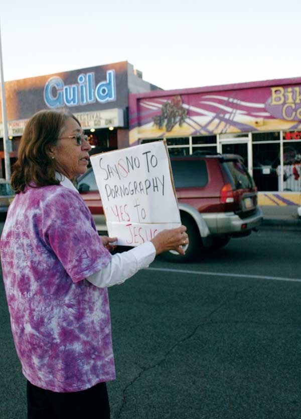 Rosemary Robles protests the Pornotopia festival in front of the Guild Cinema at 3405 Central Ave. N.E. on Sunday. 