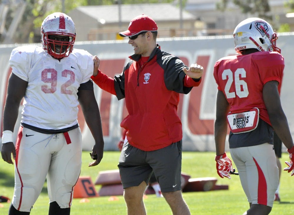 Clay Davie coaches sophomore defensive end William Udeh during Wednesdays football practice at Towe Diehm complex. Davie was promoted from offensive graduate assistant to tight ends coach.  