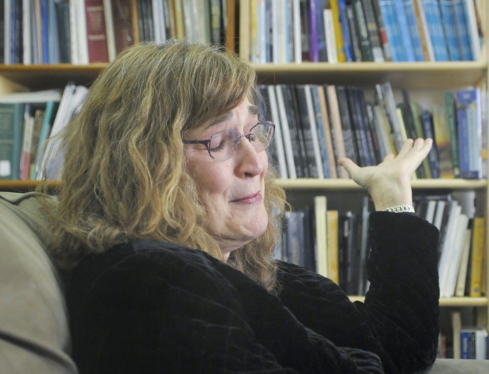 	Gail Houston, chair of the English department chokes back tears when talking about her colleague, Hector Torres. Torres was killed along with his girlfriend Stephania Gray, a graduate student, in his home on Sunday.