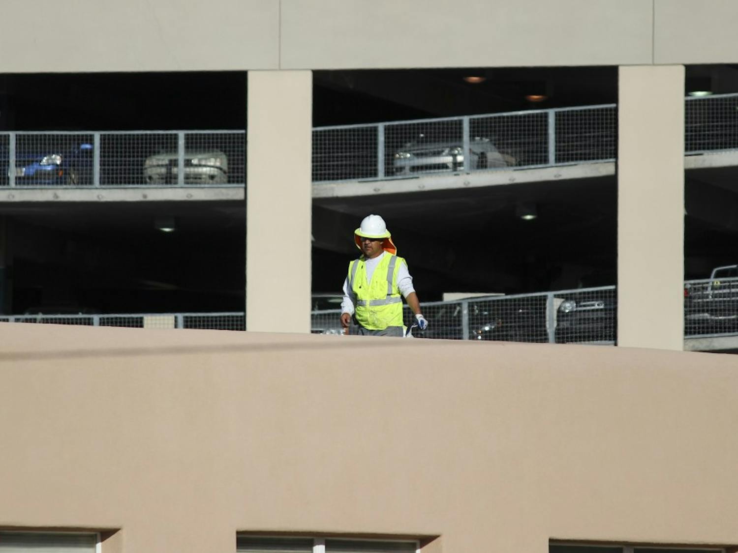 A maintenance worker fixes mastic lab seams on a parapet at the Physics and Astronomy rooftop on Tuesday afternoon. If state Senate Bill 159 passes, the old Physics and Astronomy building on Lomas Boulevard could be replaced with a new, state-of-the-art Interdisciplinary Science Building.