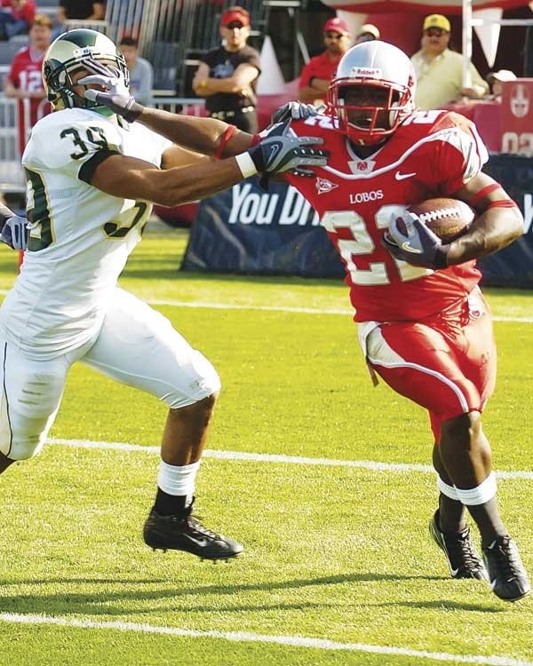 UNM tailback Rodney Ferguson pushes away Colorado State cornerback Darryl Williams on Saturday at University Stadium. The Lobos won 26-23.