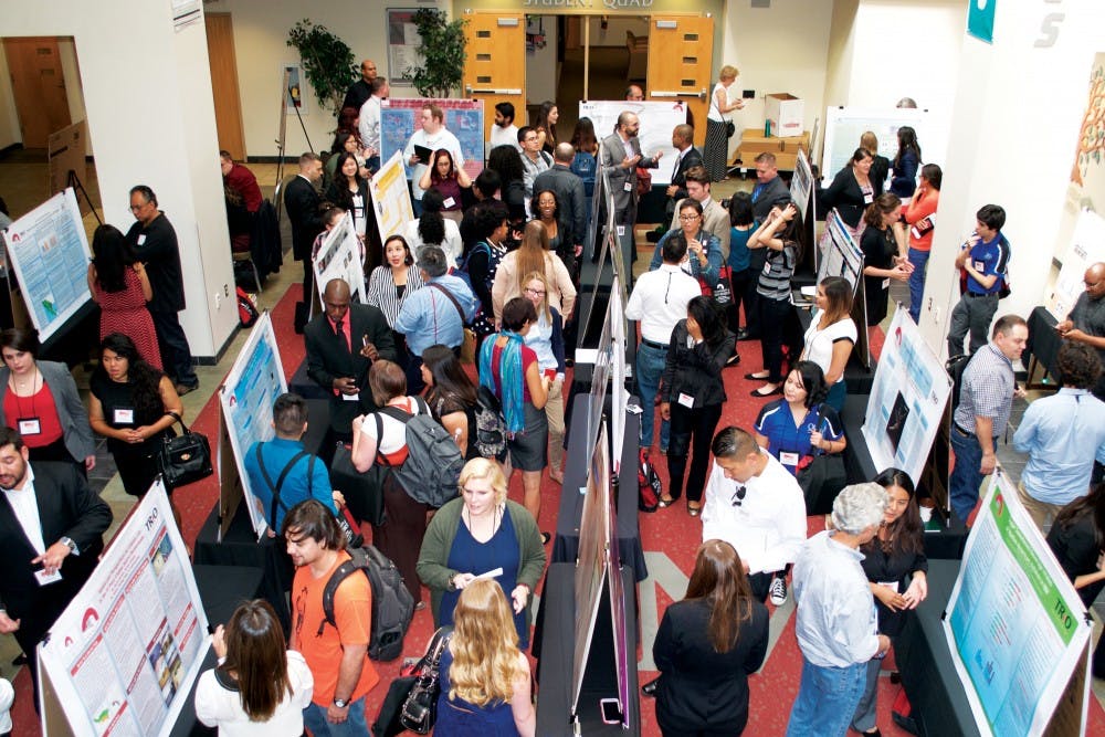 A Poster Presentations event during the 2014 McNair Scholars Conference in the SUB Atrium. The McNair Scholars Program assists students with mentors that can guide students through research that will aid them in being accepted into various graduate programs. 