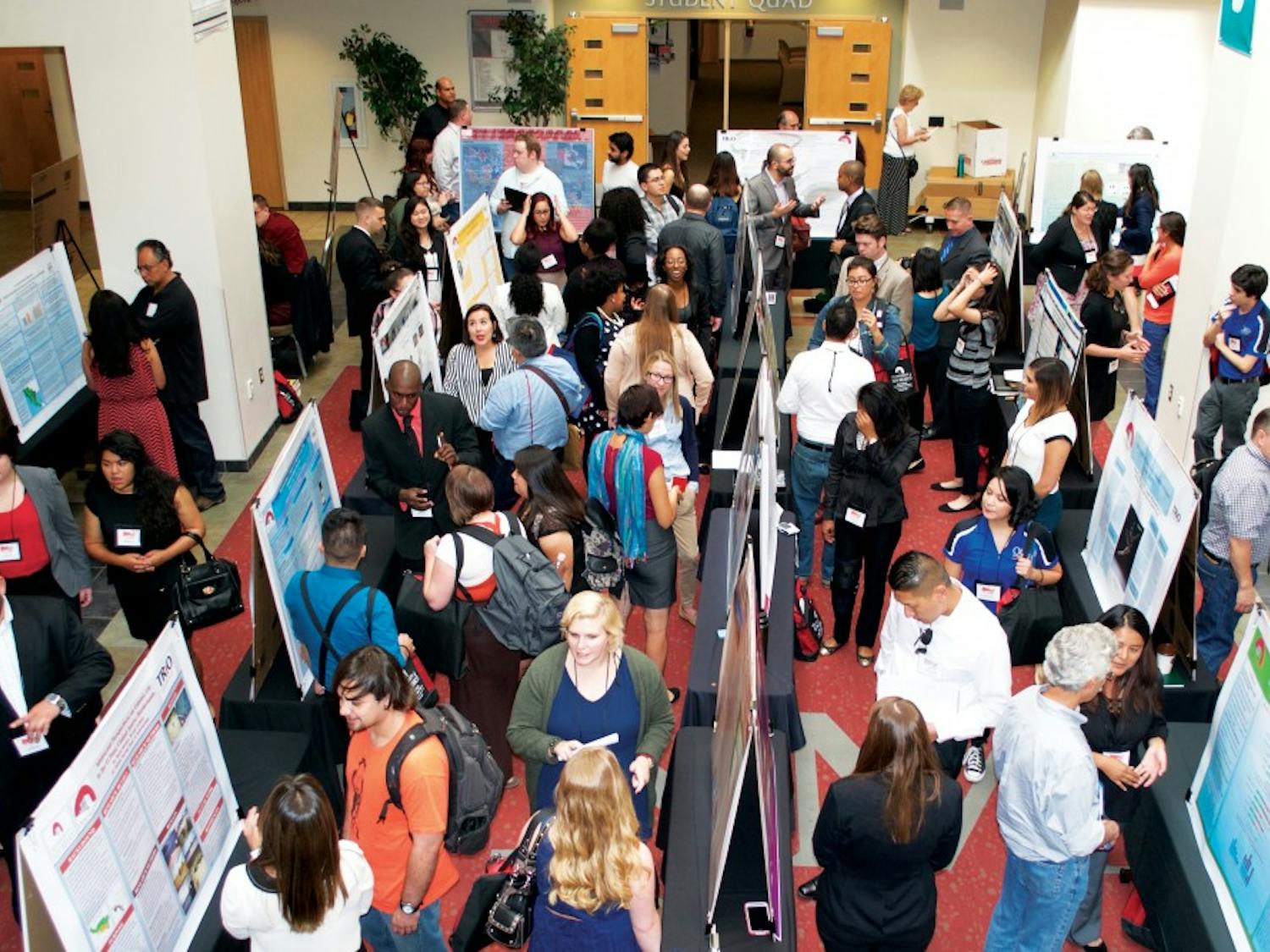 A Poster Presentations event during the 2014 McNair Scholars Conference in the SUB Atrium. The McNair Scholars Program assists students with mentors that can guide students through research that will aid them in being accepted into various graduate programs. 