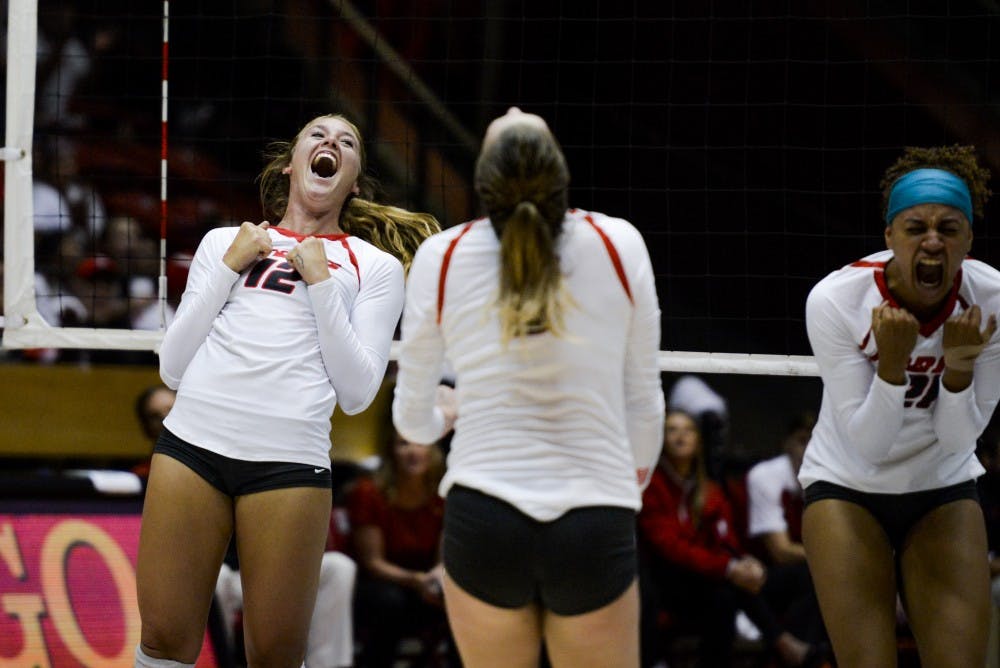 Senior outside hitter Cassie House, 12, celebrates with teammates after scoring against Nebraska on Saturday, Sept. 10, 2016 at WisePies Arena. UNM won three out of its four games this weekend at the UT Arlington Invitational.