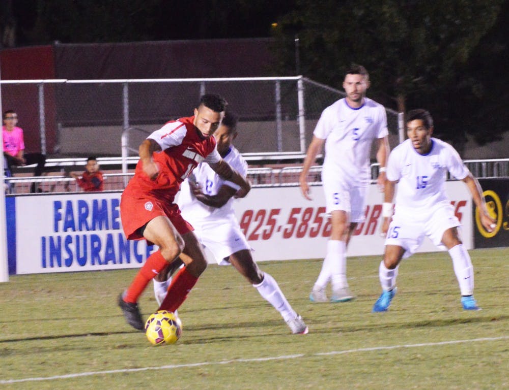 Lobo forward Niko Hansen battles with a Kentucky player during their game Sunday Oct. 4, 2015. The Lobos fought their way into overtime but lost the game 0-1. 