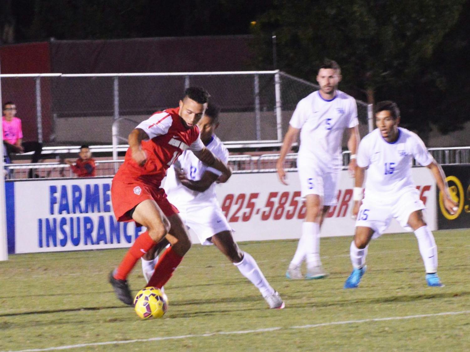 Lobo forward Niko Hansen battles with a Kentucky player during their game Sunday Oct. 4, 2015. The Lobos fought their way into overtime but lost the game 0-1.