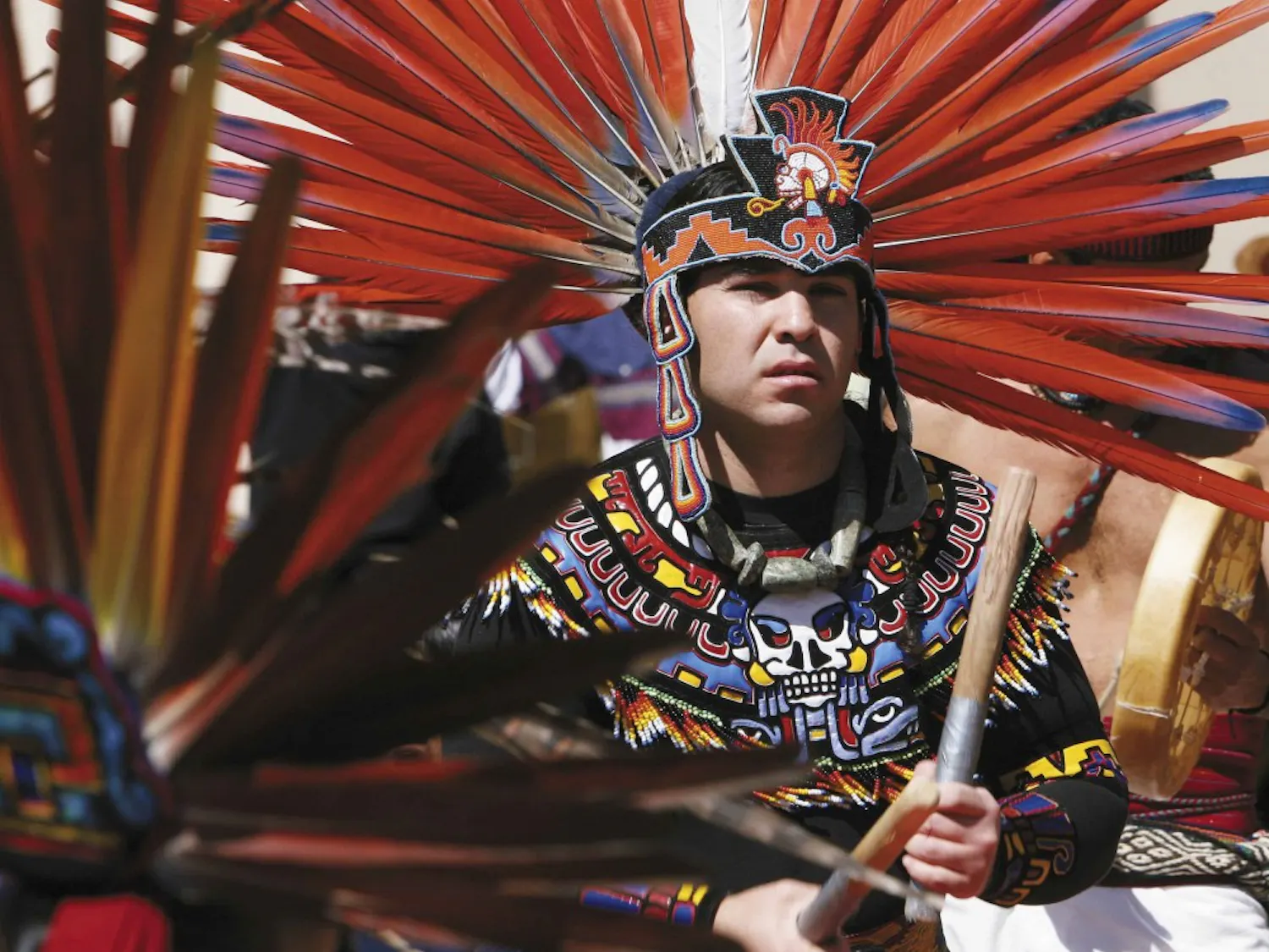 Dancer Luis Garcia performs a blessing with other Aztec dancers as part of a C