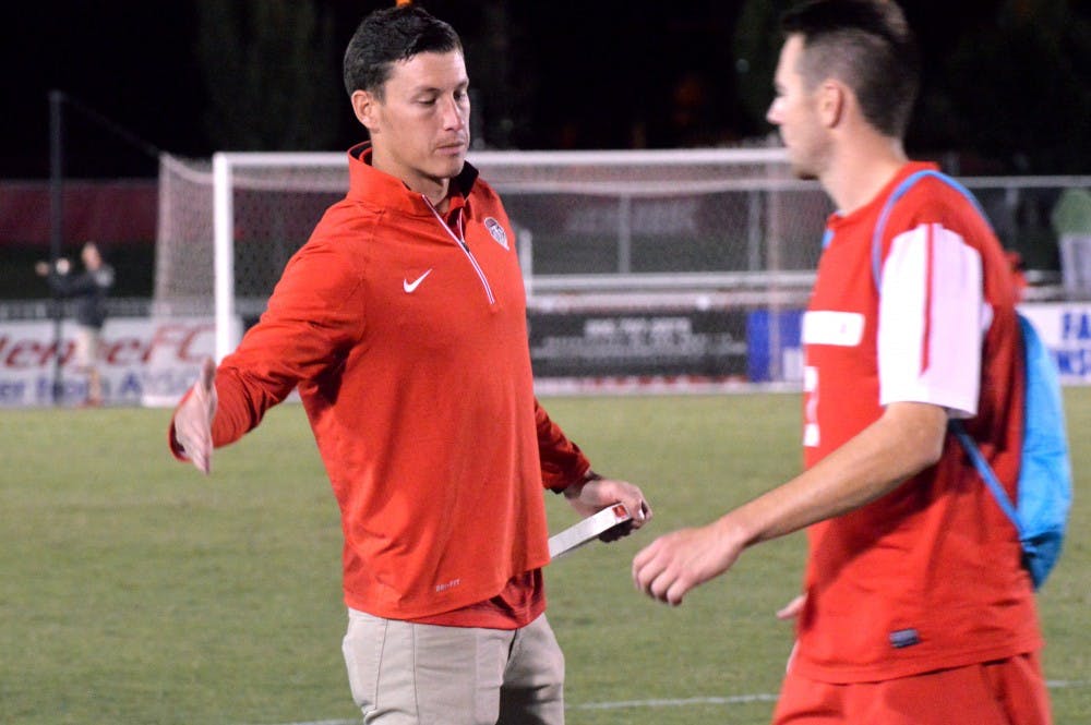 Lobos Mens Soccer Director of Operations Travis Campbell congradulates midfielder Josh Goss after their game against Kentucky State. Campbell has been the Director of Operations for the Lobos for two seasons now. 