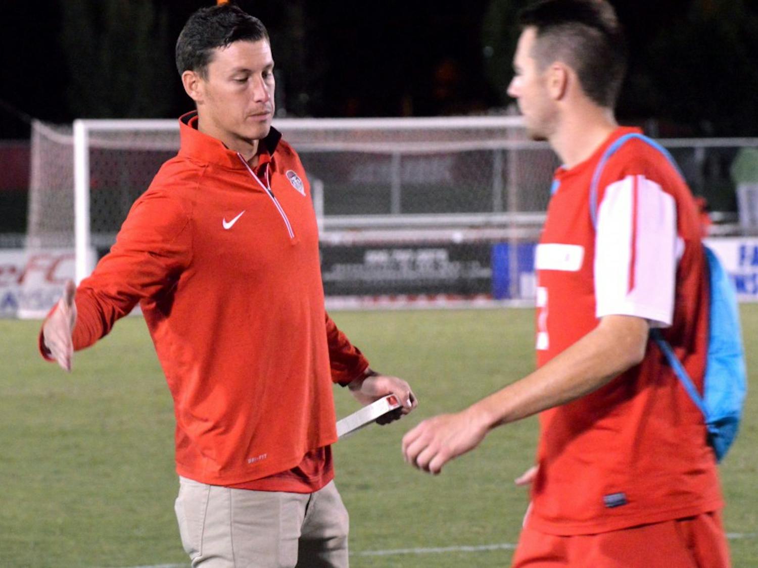 Lobos Mens Soccer Director of Operations Travis Campbell congradulates midfielder Josh Goss after their game against Kentucky State. Campbell has been the Director of Operations for the Lobos for two seasons now. 