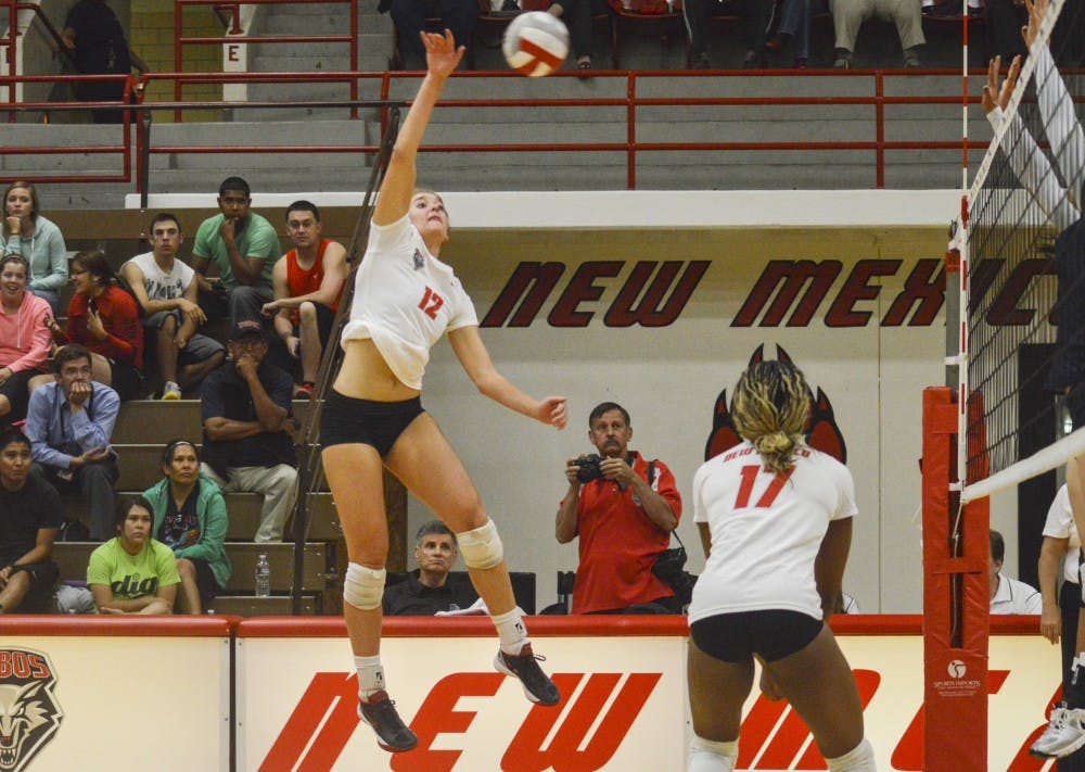 UNM sophomore outside hitter/middle blocker Cassie House spikes the ball during the game against Utah State at Johnson Gym on Thursday night. The Lobos will play at San Diego State Thursday night at 7 p.m.