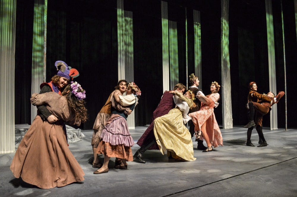 Actors from the play As You Like It dance on stage.