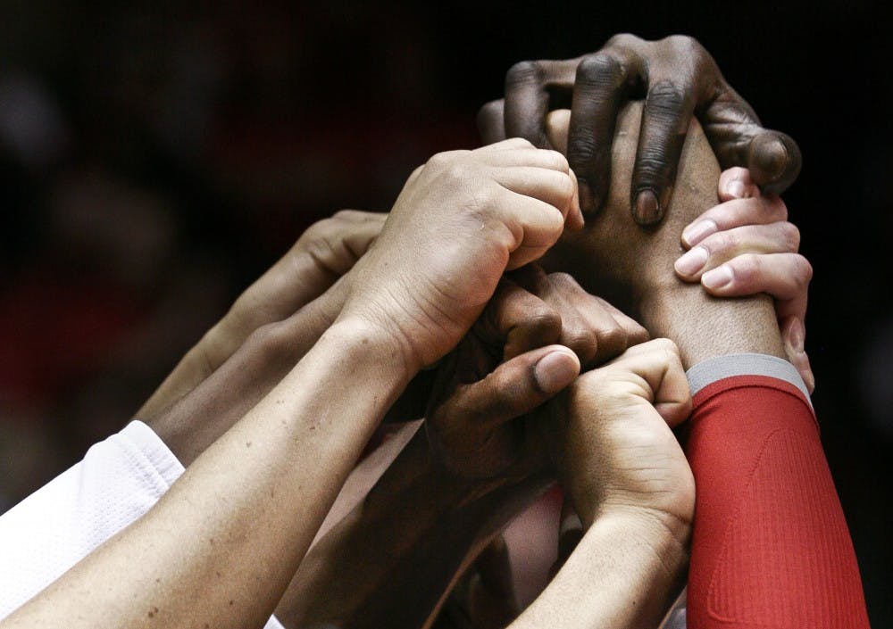 	Memers  of the UNM men’s basketball team clasp hands before taking the court last season during a game at The Pit. The Lobos will christen a renovated University Arena this season and will look to exceed expectations set after last year’s historic season.