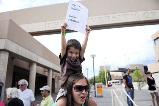 Darisa A. and her son Nima protest the results of the June 12 Iranian elections in the front of the UNM Bookstore on Friday. Much of the opposition was incited by Iranian university students.
