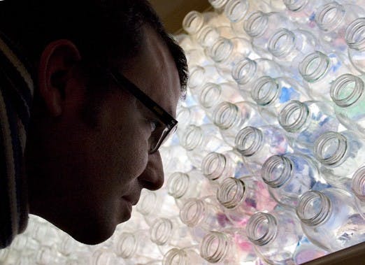 Omar Contreras looks at "48 Days," an art project by Jonathan Hawes, during the opening night of "Land Art Students Exhibit" at [AC]2 Gallery.