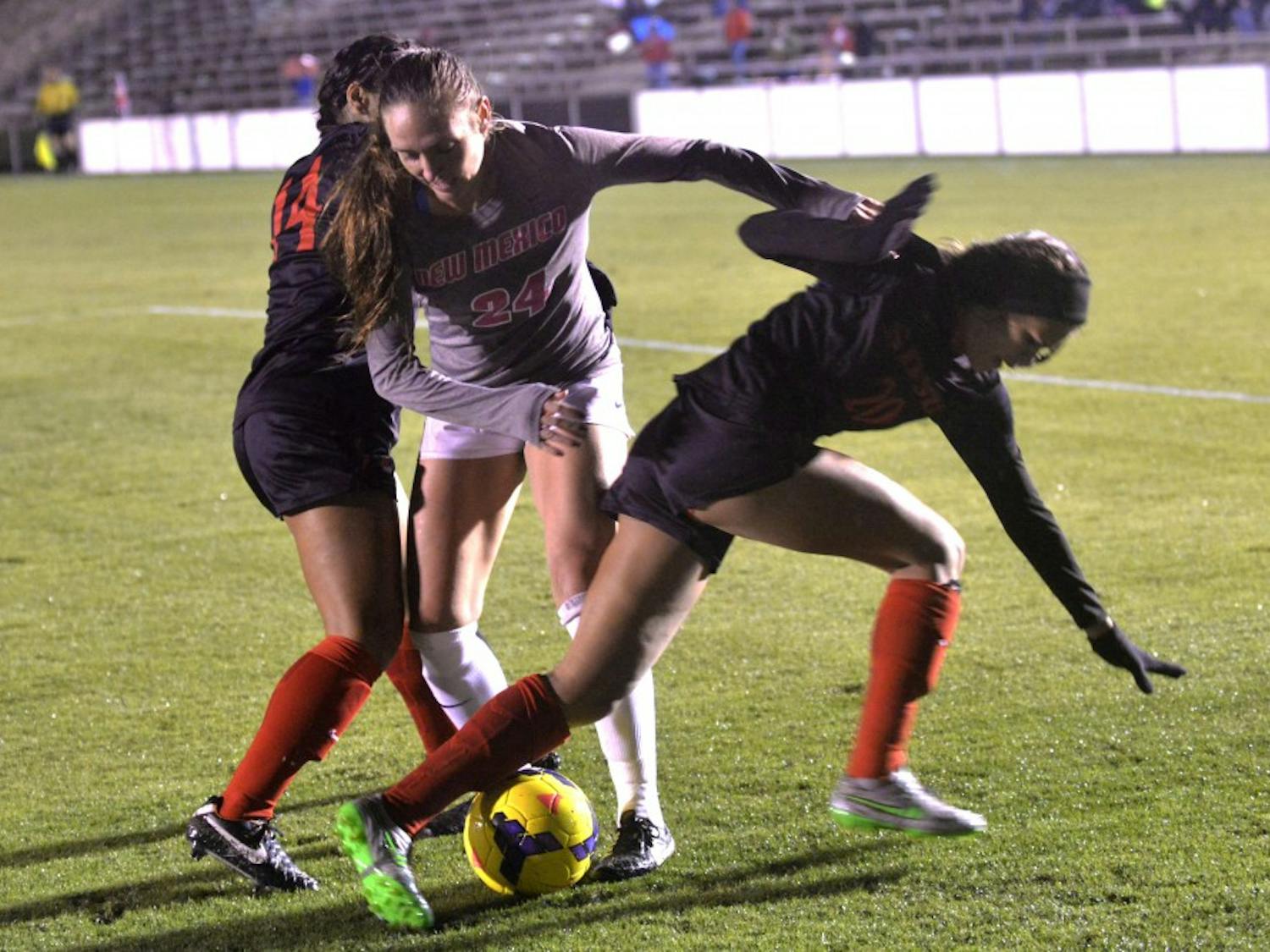 Senior forward Madisyn Olguin fights off two San Diego State players at the UNM Soccer Complex Friday night. The Lobos lost to San Diego State 2-1 and will begin play in the Mountain West tournament Tuesday against UNLV.