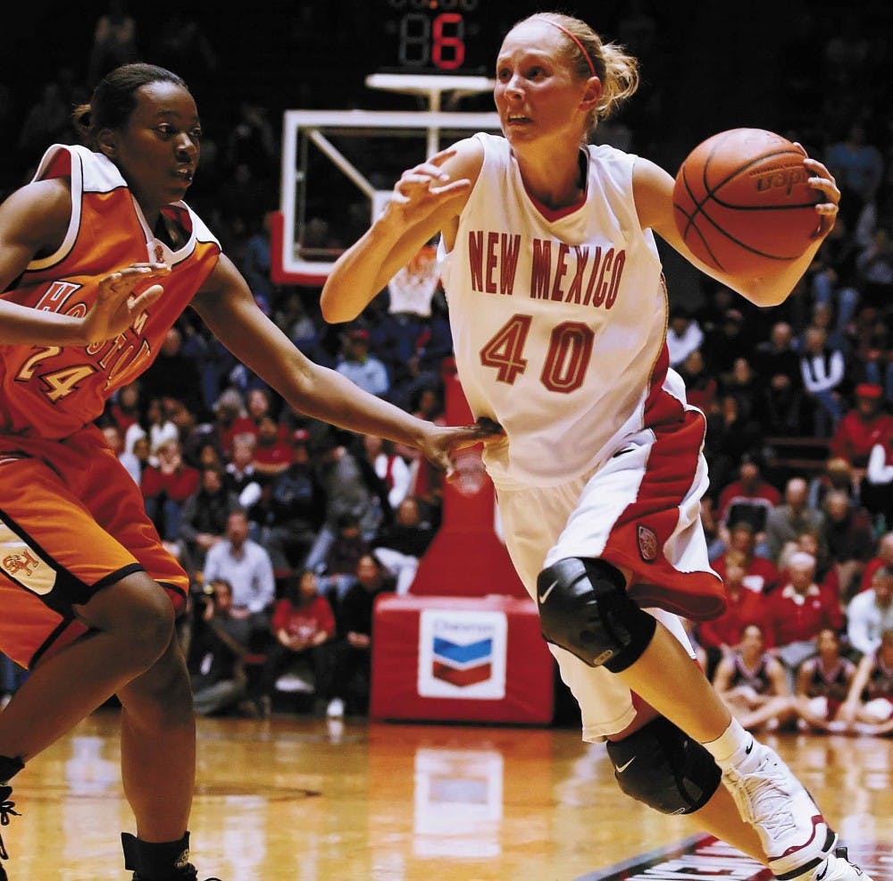 UNM guard Julie Briody dribbles past Sam Houston State forward Whitney Smith during the second half of Saturday's game at The Pit. The Lobos won 77-41.