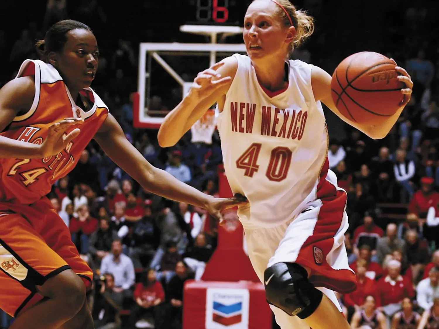 UNM guard Julie Briody dribbles past Sam Houston State forward Whitney Smith during the second half of Saturday's game at The Pit. The Lobos won 77-41.