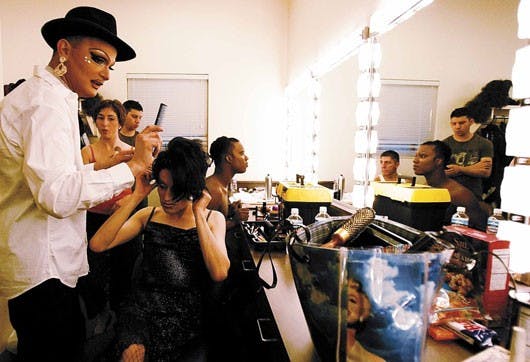 Drag queen Cassandra De La Noche, left, does drag queen Victoria Velasquez's hair in a dressing room while preparing to perform during the "Come Out, Come Out, Wherever You Are: Paris is Burning . Life is a Masquerade" show at the National Hispanic Cultur