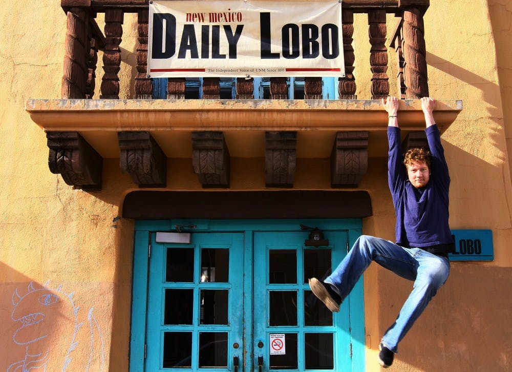 	Pat Lohmann, new Daily Lobo editor-in-chief, dangles from a balcony at Marron Hall. Lohmann wants to focus on investigative reporting and transparency during his tenure as editor. 