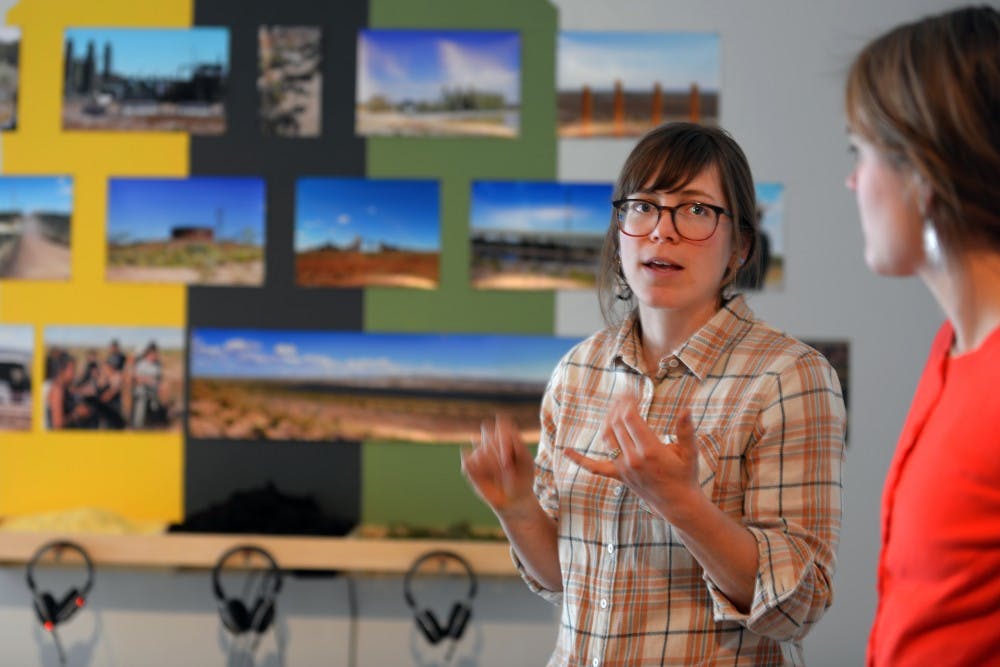 UNM graduate student Kacie Erin Smith talks about the Land Arts of the American West project Friday afternoon&nbsp;at the College of Fine Arts&nbsp;Downtown Studio. The exhibition displayed creative works to portray social and environmental justice issues.&nbsp;&nbsp;