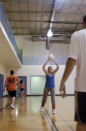 Jennifer Ruelas sets a ball to Steve Parra before a volleyball game for Lobo League in Johnson Gym on May 17. The University has plans to build a new recreation center, which would require increasing student fees by more than $100 per semester.