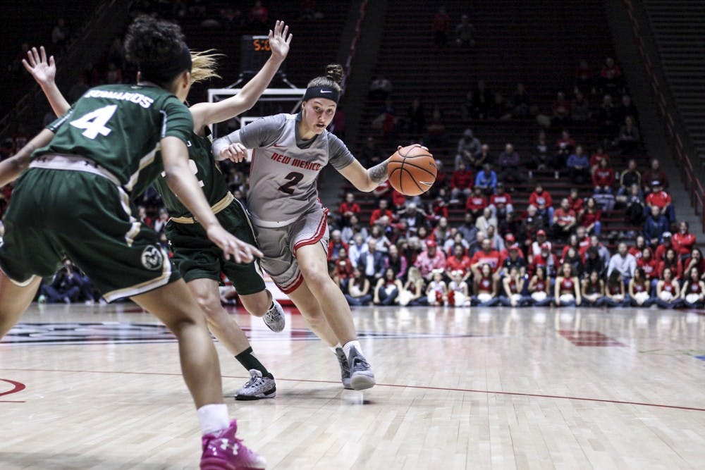 Senior Tesha Buck dribbles against two players from Colorado State on Feb. 27, 2018 at the Dreamstyle Arena. The Lobos won 54-48 against Colorado State.