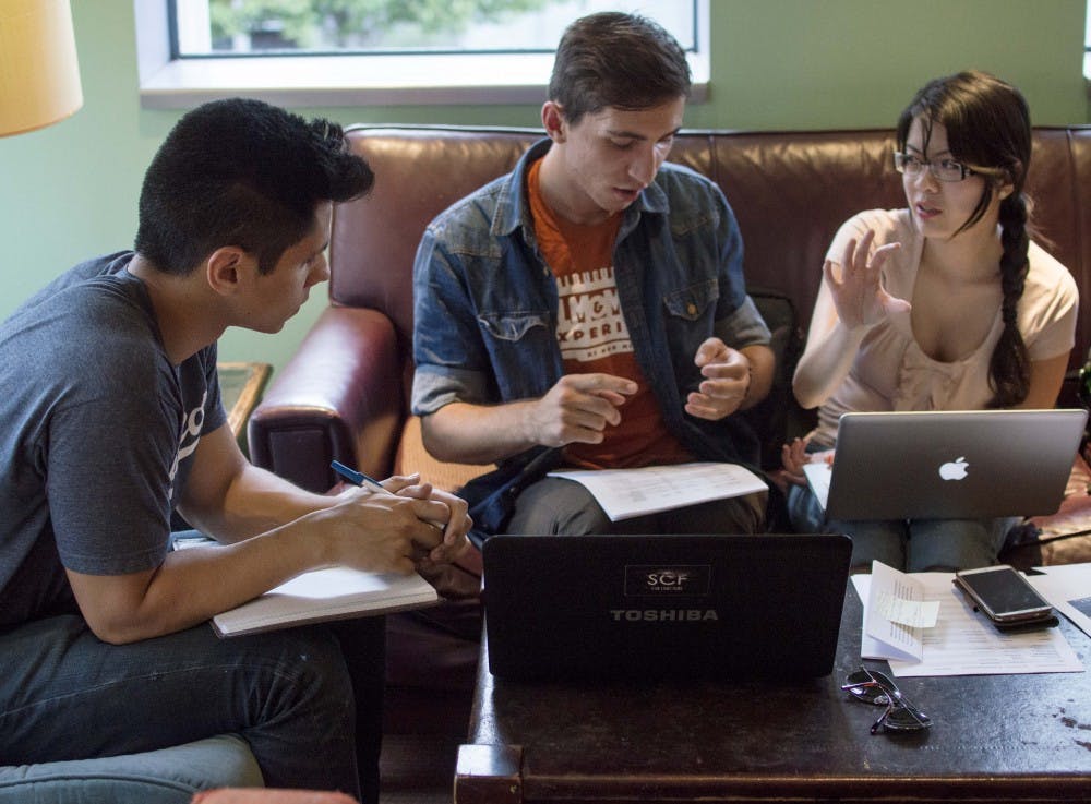 	(left to right) Alex Deeds, a freshman undeclared major; Djochoua Belovarski, a senior media arts major; and Megan Pham, a senior media arts major, read through a script for a science fiction film they are producing at the Flying Star in downtown Albuquerque on Thursday afternoon. Belovarski said they have been working on the film for two years.