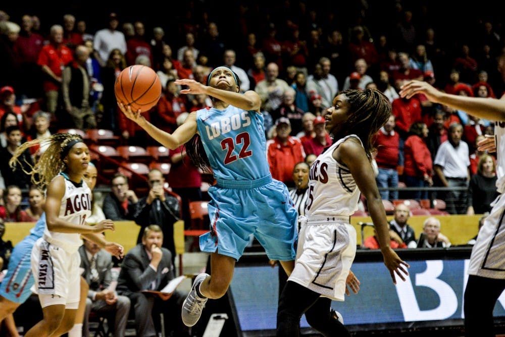 Freshman Mykiel Burleson jumps past a New Mexico State player during UNM's game on Tuesday, Nov. 15, 2016 at WisePies Arena. The Lobos will face off against Tulsa this Friday in their first game of UNM Thanksgiving Tournament.&nbsp;