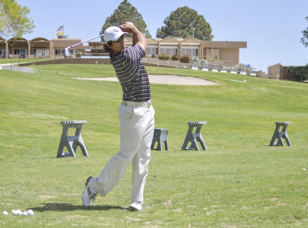 	UNM golfer Gavin Green follows through on a shot from the driving range Tuesday afternoon at the UNM Championship Golf Course.