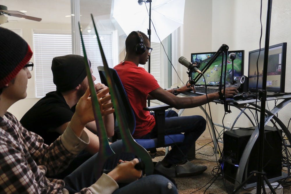 Billy Hargraves plays League of Legends while Zach Cordova and Jason Denbigeh watch him play on Sunday, Jan. 24, 2015. They each live stream different games for at least 21 hours a week.