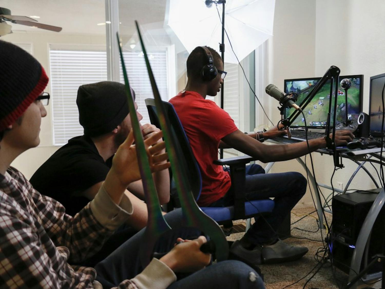 Billy Hargraves plays League of Legends while Zach Cordova and Jason Denbigeh watch him play on Sunday, Jan. 24, 2015. They each live stream different games for at least 21 hours a week.