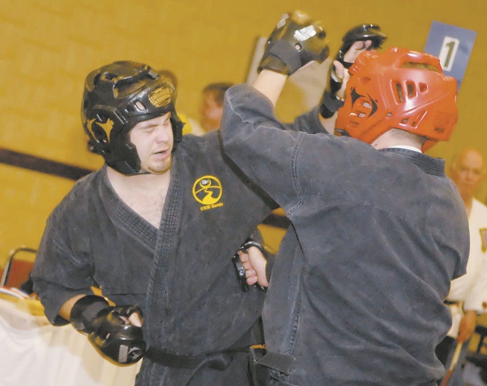 UNM Karate Club member Uriel Lapcevic, left, spars with Christopher Hawkes during the last round of United States Karate Alliance Nationals Tournament on Saturday at the Albuquerque Marriot Pyramid North. 