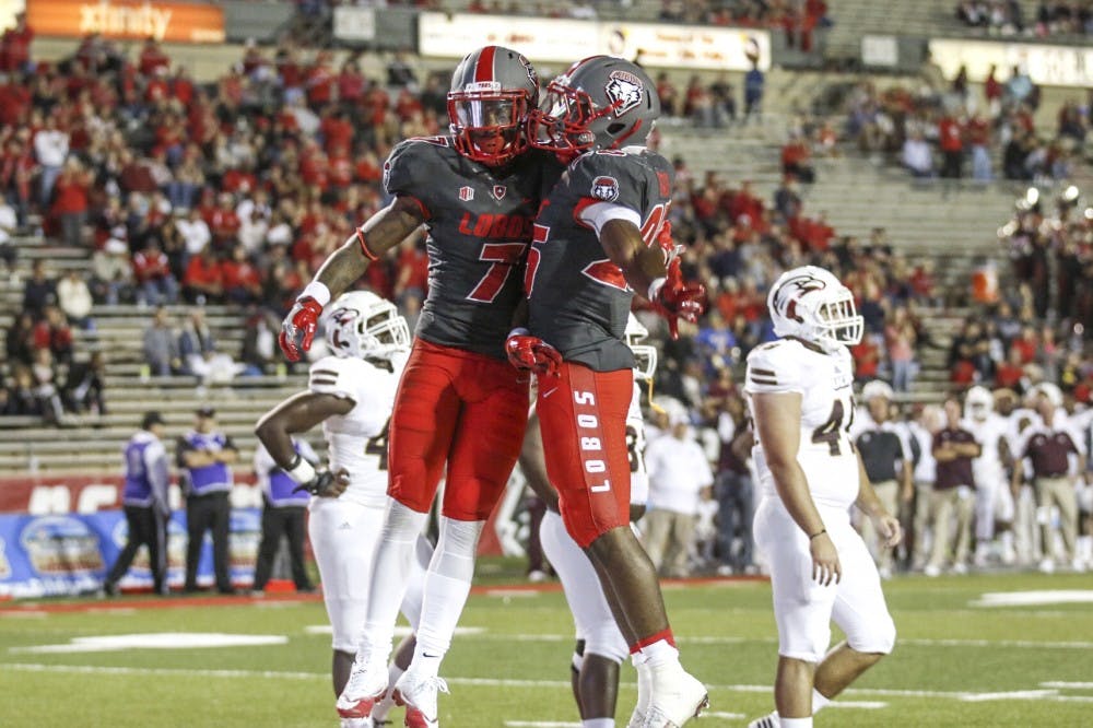 Senior running back Teriyon Gipson, left, celebrates during the Lobos' game against Louisiana-Monroe at University Stadium on Saturday, Oct. 22, 2016. The Lobos defeated LMU 59-17.&nbsp;