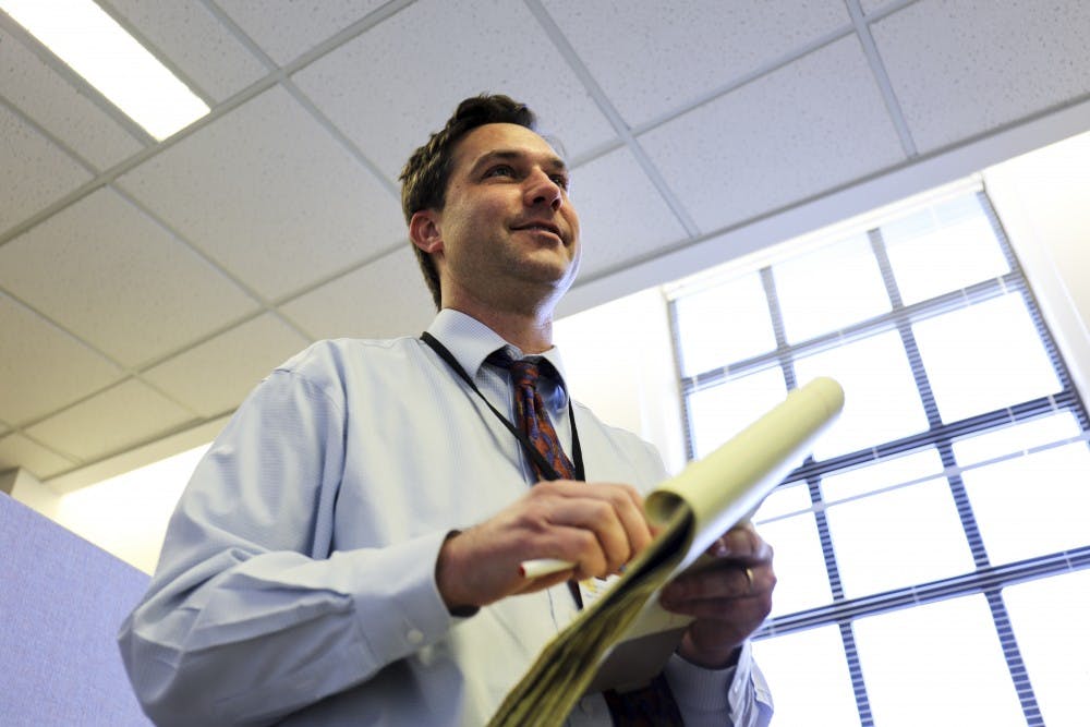 Albuquerque Journal staff writer Dan McKay speaks to senator George Munoz on Jan. 26, 2018 at the Santa Fe Roundhouse.  