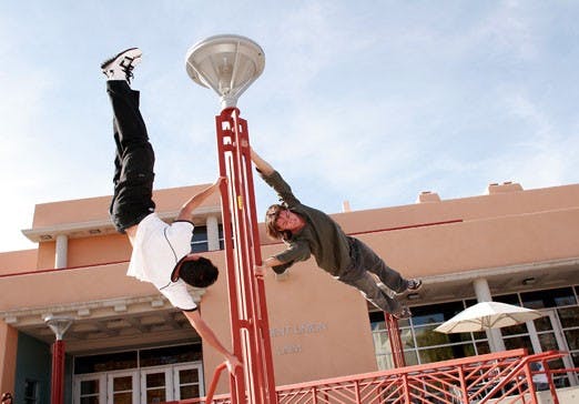 Zack Wright, left, and Matt Stoltzfus practice parkour outside the SUB on Monday. Wright and Stoltzfus are part of group called Free Running that meets at noon every other Saturday on campus.