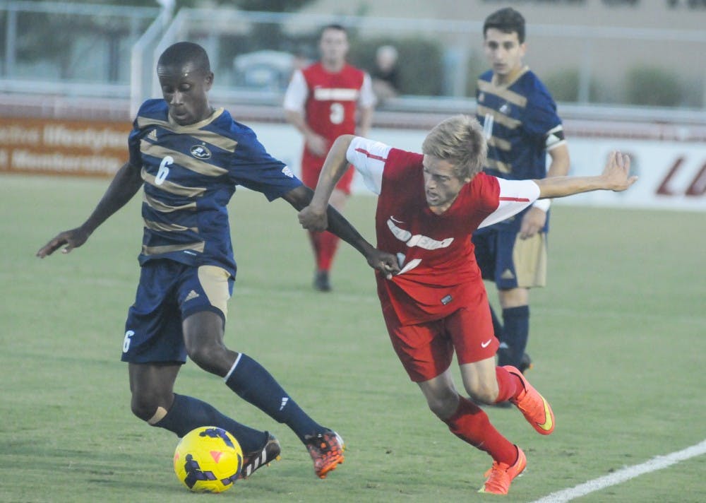 	UNM redshirt sophomore Christopher Wehan defends the ball from Akron blueshirt freshmen Richie Laryea during the game against Akron at the Lobo Soccer Complex on Saturday night. The Lobos won the game to a 1-0. 