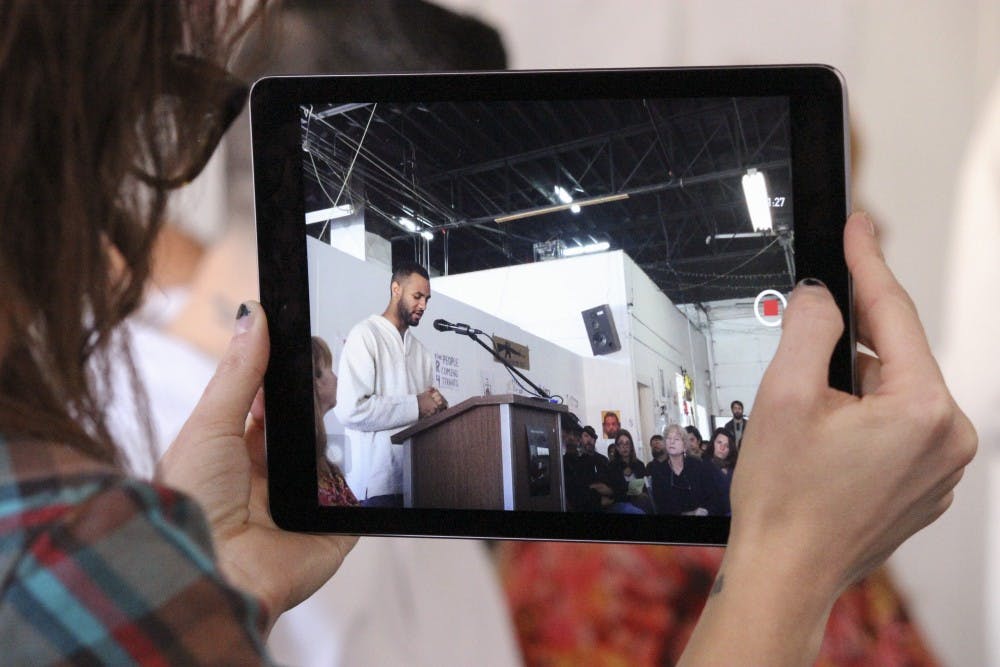 Jill Jurkiewicz records Andrew Nances speech for the Albuquerque Peoples Tribunal on Police Brutality meeting on Saturday afternoon at Kinley Avenue. Nance was one of many speakers who spoke about the impact police brutality has on the community. 