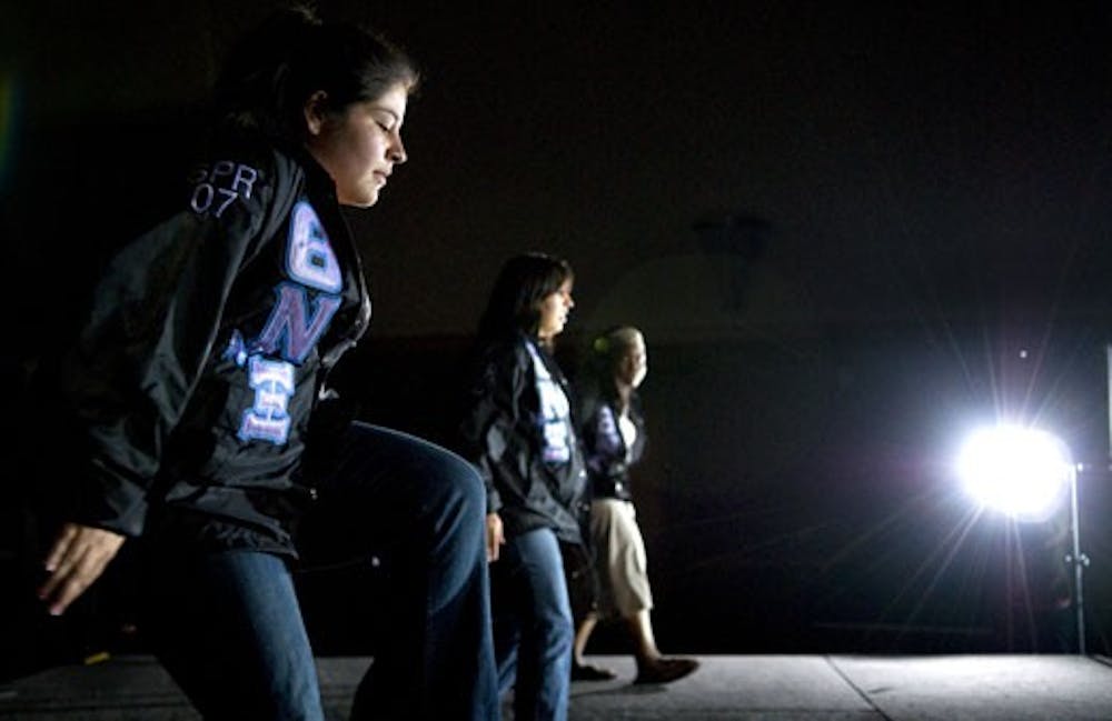 Students Amanda Pacheco, left, Christina Lovato and Ramona Smith of Theta Nu Xi Multicultural Sorority Inc. rehearse a skit Sunday for Greek Week.