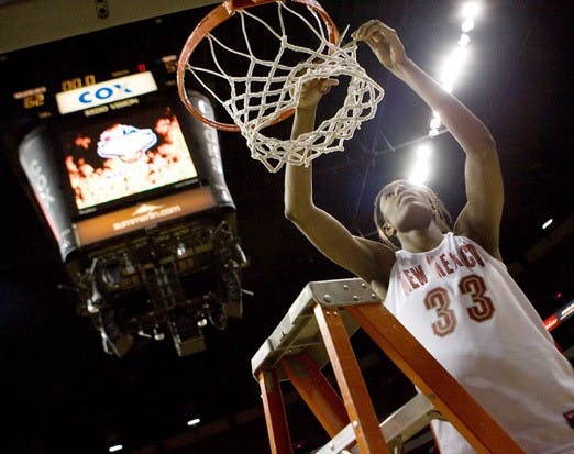 UNM's Dionne Marsh cuts down a part of the net after the Lobos won the 2008 MWC tournament.