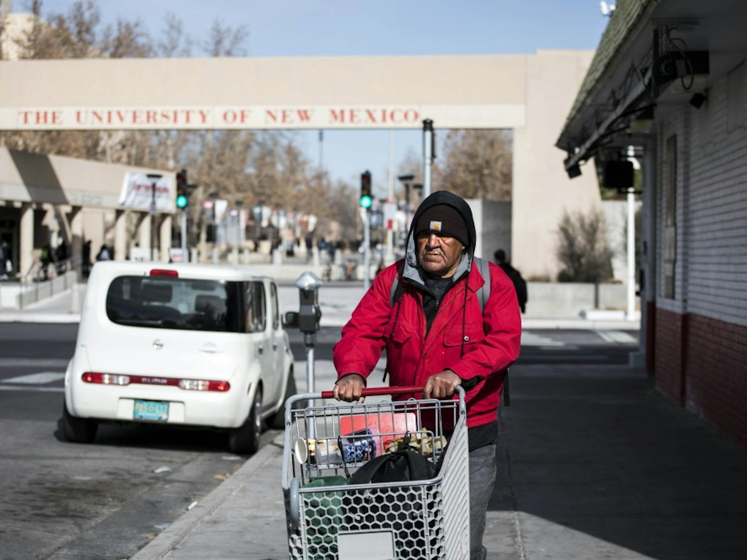 An Albuquerque homeless man transports his belongings down Central Avenue via shopping cart on the evening of Jan. 17, 2018.