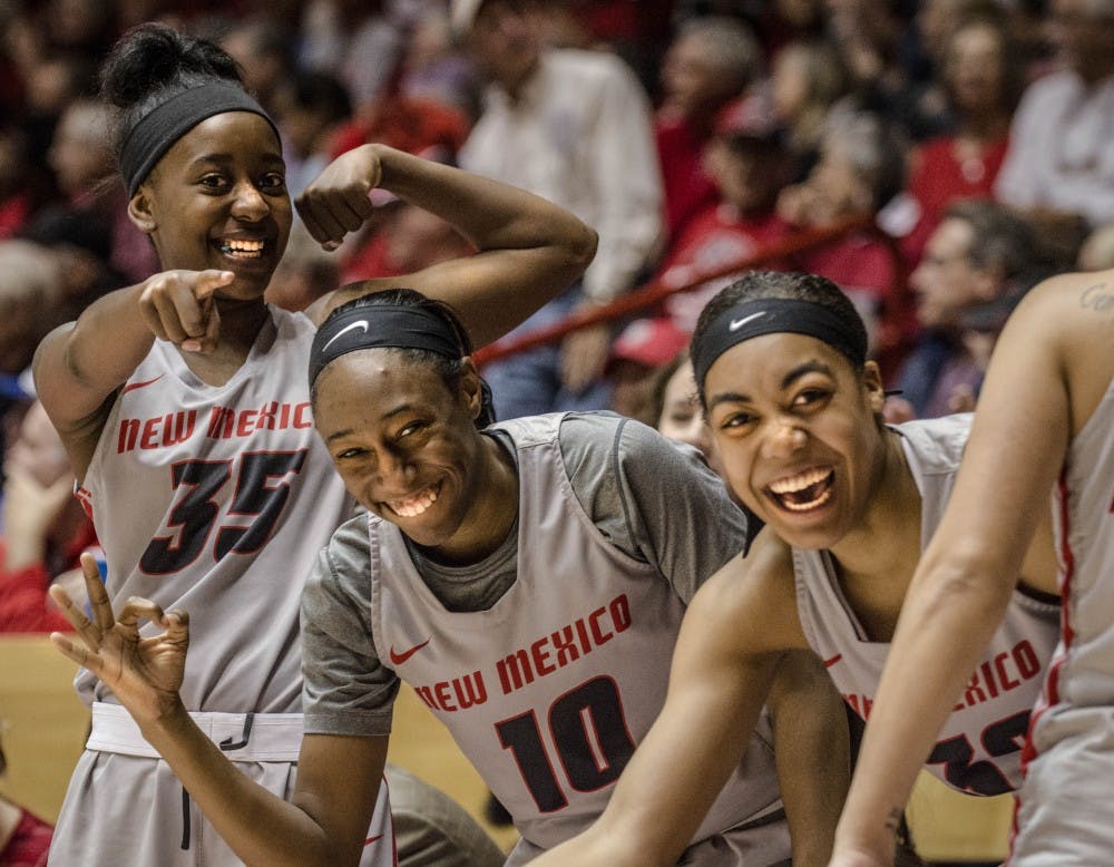 Madi Washington, (35), Jasmine Smith, (10), Antonia Anderson,  (32),  celebrate after teammate Alex Lapeyrolerie sinks one of the teams combined 18 three pointers at Dreamstyle Arena, November 26, 2017. The Lobos defeated the Illinois University Fighting Illini during the Championship game of the UNM Thanksgiving Tournament, 97-68, solidifying their 7-0 record.
