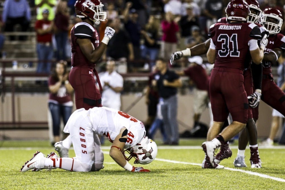 Senior line backer Dakota Cox hits the turf&nbsp;as NMSU players celebrate around him Saturday, Sept. 10, 2016 in Las Cruces, New Mexico.&nbsp;The Lobos lost to the Aggies for the first time&nbsp;since 2011 by a score of 32-31.&nbsp;&nbsp;