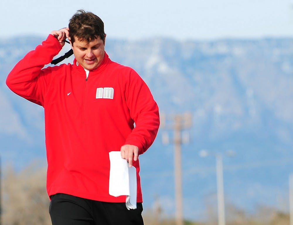 	New quarterback coach David Reaves flips off his visor while going through drills with quarterbacks and wide receivers during a practice at the UNM football practice fields on Thursday.