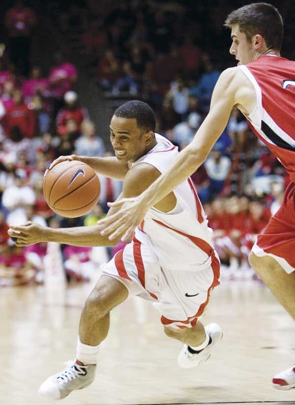 UNM's Jamaal Smith dribbles past a Southern Utah defender during Wednesday's game at The Pit. The Lobos won 57-48.