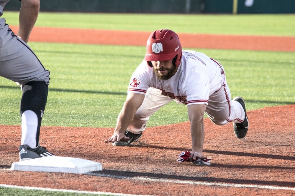 Senior Jared Holley slides back into first base before an NMSU player could get him out Tuesday April 26, 2016 at Santa Ana Star Field. UNM beat the Aggies 3-2 on Tuesday night.